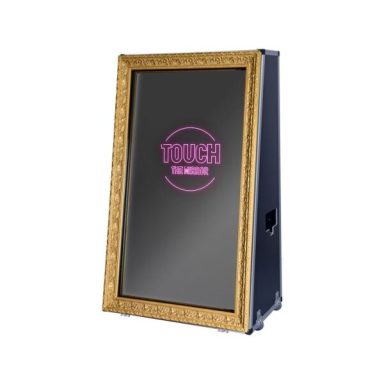 A decorative mirror with the text "TOUCH" in pink, framed in gold.